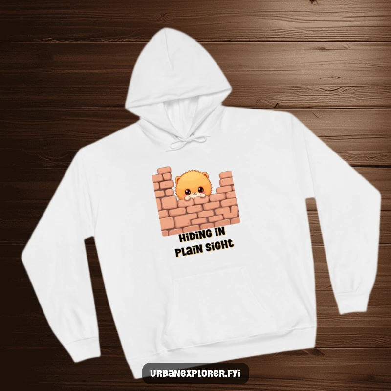 Funny Fluffy Creature Hoodie: A warm hoodie featuring a fluffy creature peeking from behind a brick wall, ideal for a funny gift.