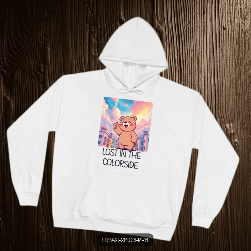 Funny bear character pointing upwards at a surreal, colorful sky above buildings, depicted as cozy and whimsical, ideal for a funny gift hoodie.